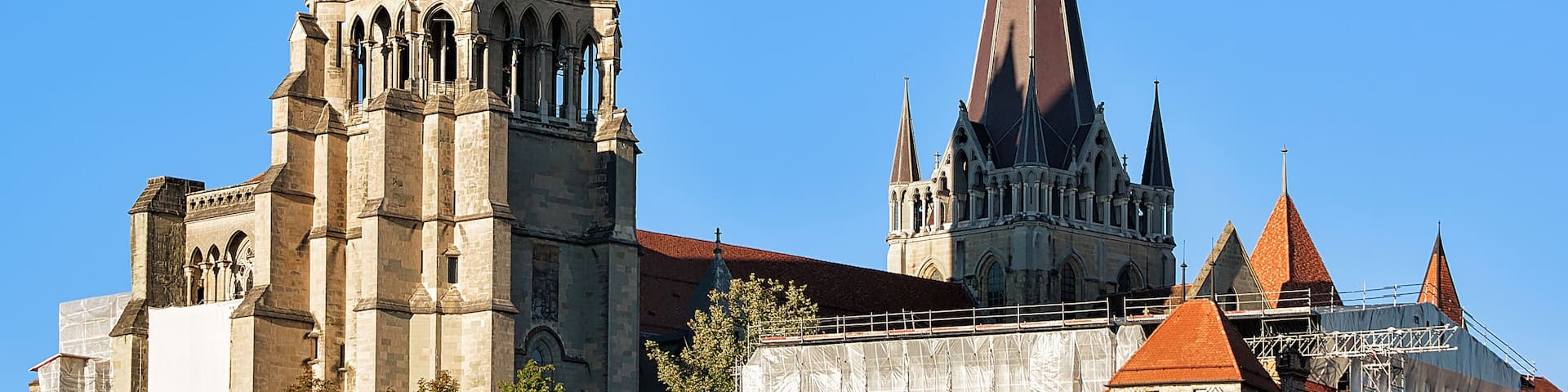 A historic cathedral with multiple spires and a large clock tower.