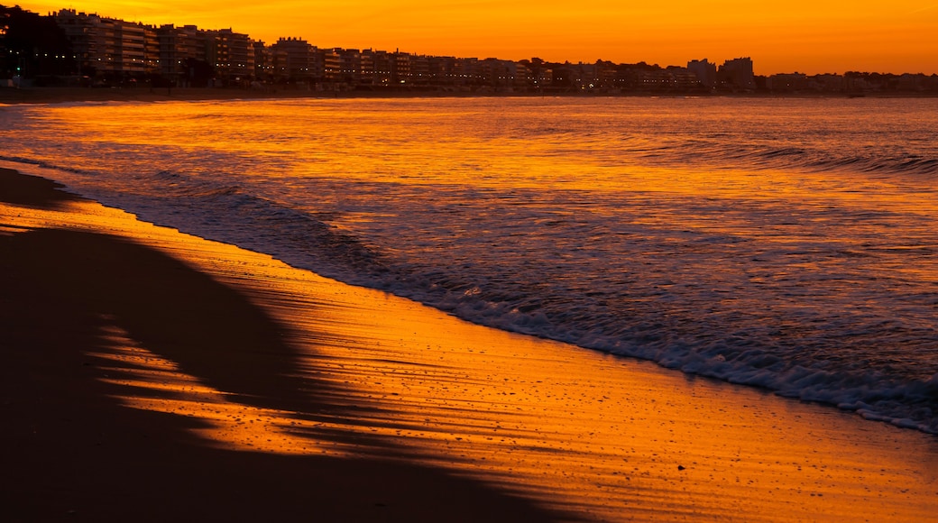 Amazing view of a fiery sunrise with multicolored clouds. Sea waves along the seashore at sunrise. Morning time. Ocean view. La Baule-Escoublac, France