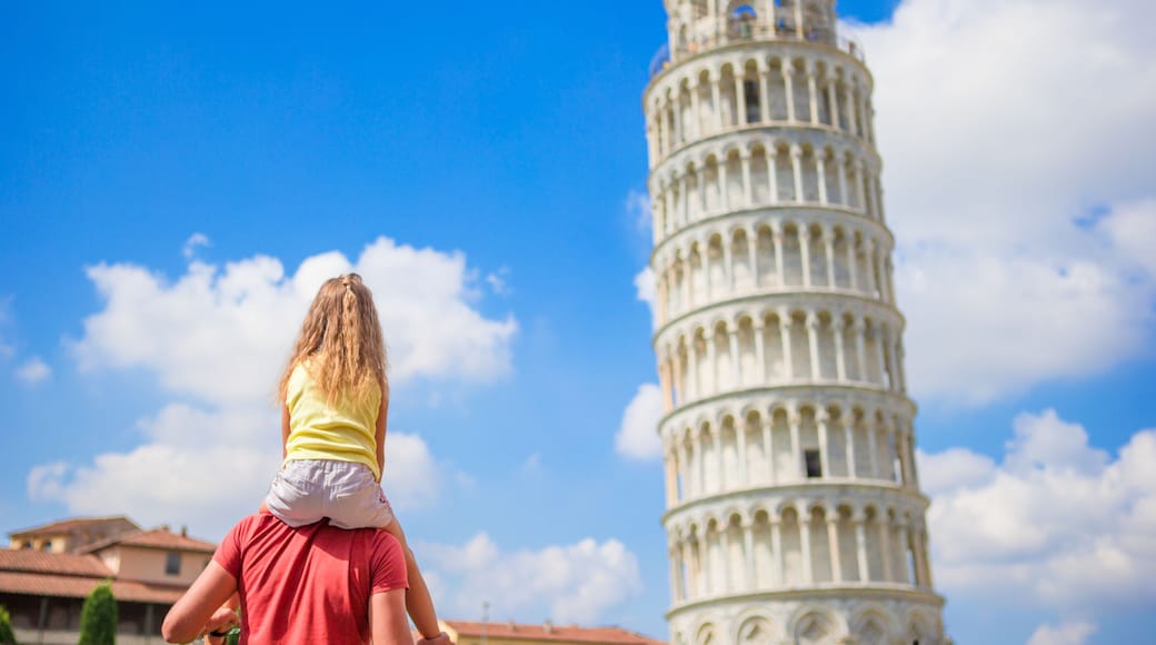 Family of dad and kid background the Learning Tower in Pisa. Pisa - travel to famous places in Europe.