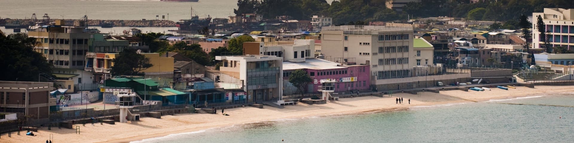 Cheung Chau which includes a sunset, a beach and a coastal town