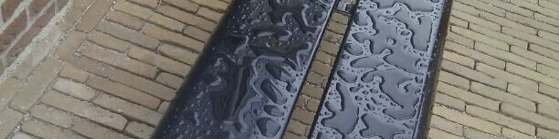 In between this fake buildings, the waterpatterns on an iron bench suddenly are of utmost beauty