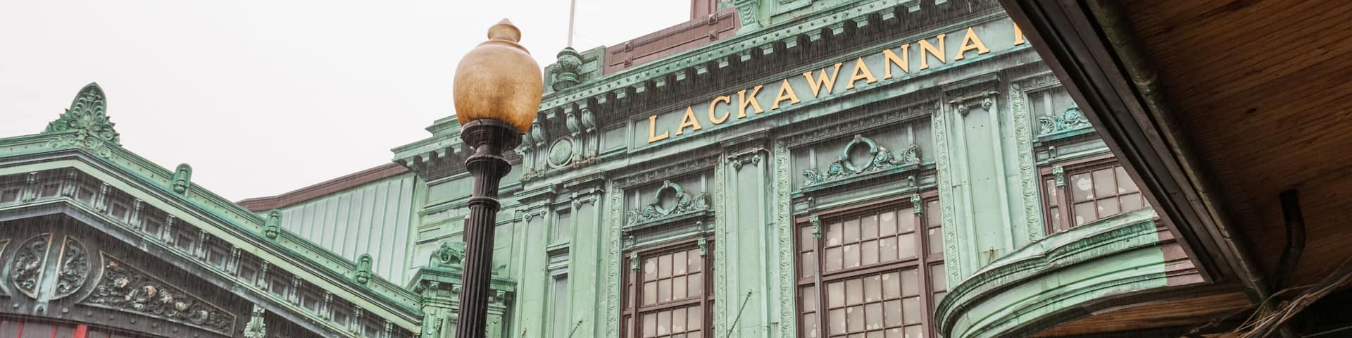 A historic building with a clock tower and a sign that reads "Lackawanna Waiting Room."