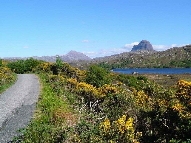 The road to Glencanisp Lodge Loch Druim Suardalain, Suilven and Canisp visible.