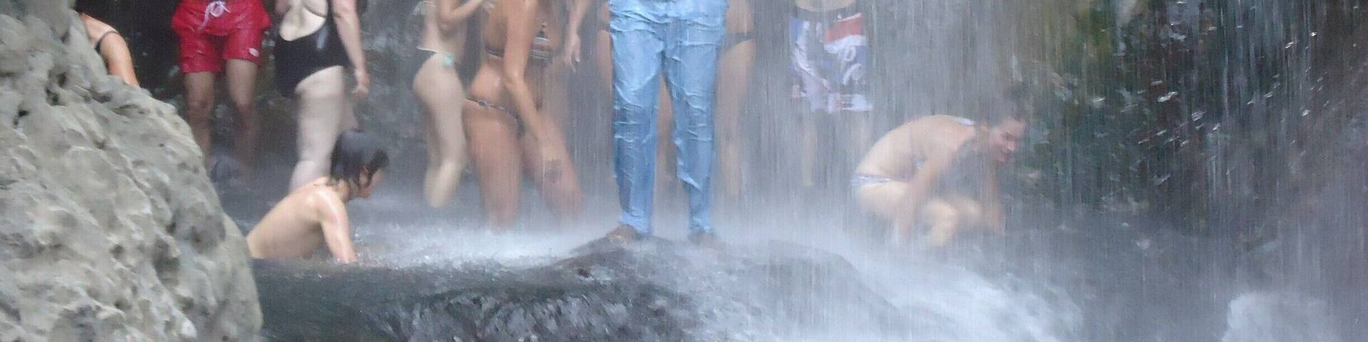 This tourist decided to have a swim at the waterfalls with their guide Steven, but steven refused to put in a swim suite claiming that he was a married maasai.