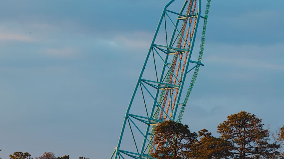 A tall amusement park ride against a twilight sky.