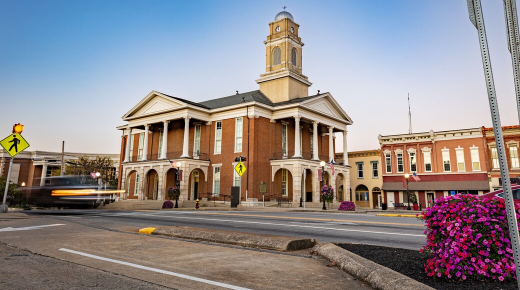 Morning traffic headlights illuminate the downtown square in Lancaster, Kentucky, with the historic courthouse as a backdrop in this small American town.
