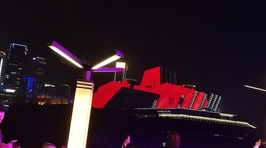 Chongqing Grand Theatre is grey by day. At night, when the city lights up, the theatre is transformed into a rainbow of colours which emphasise its striking architecture.