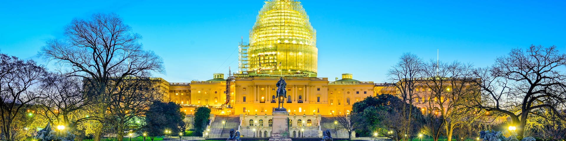The United States Capitol building with its reflection in a body of water.
