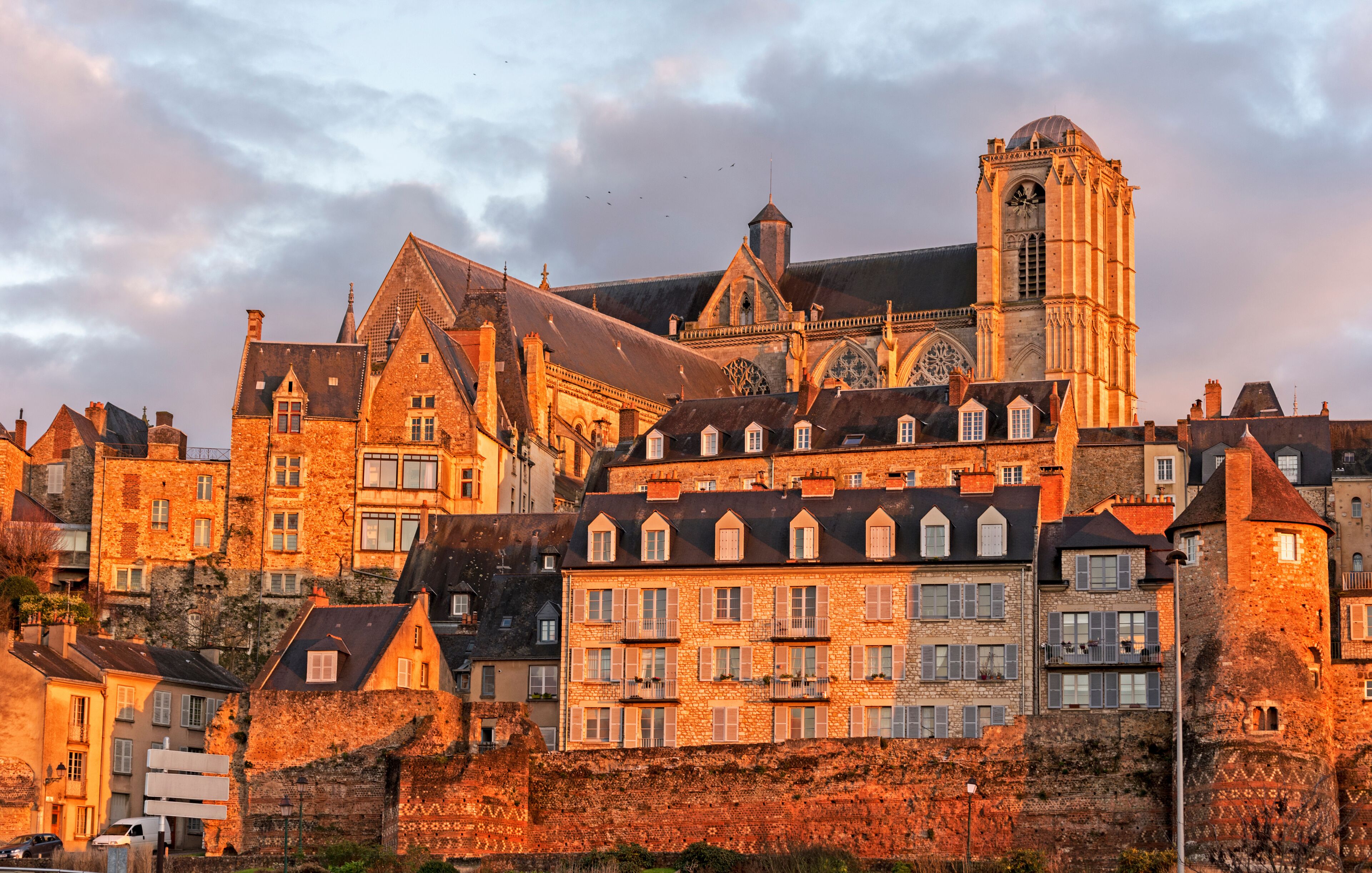 A historic European town with a prominent cathedral and surrounding stone buildings.
