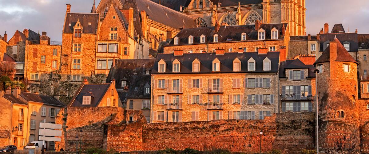 A historic European town with a prominent cathedral and surrounding stone buildings.