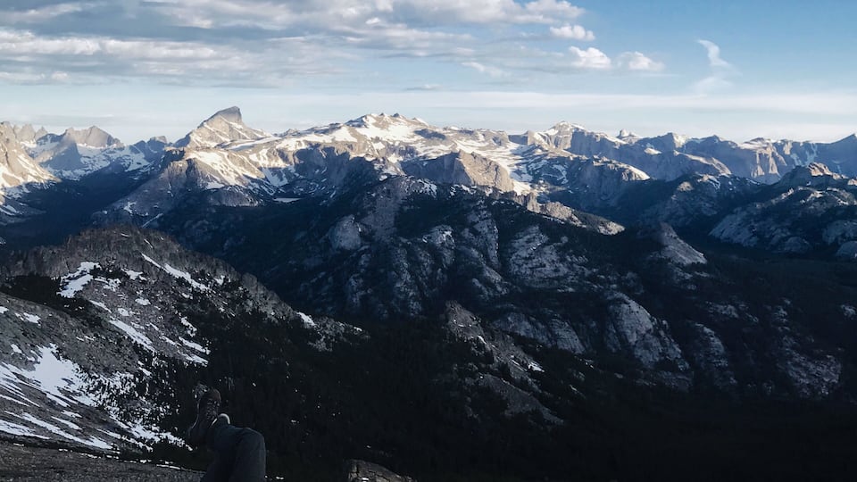 A mountain range with snow-capped peaks and a clear sky.