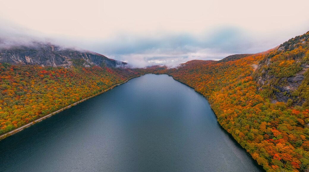 Epic Fall Foliage Over Lake Willoughby Vermont Autumn Season Aerial Drone View. Early Morning Calm Water Colorful Trees Low Clouds in Distance Wide