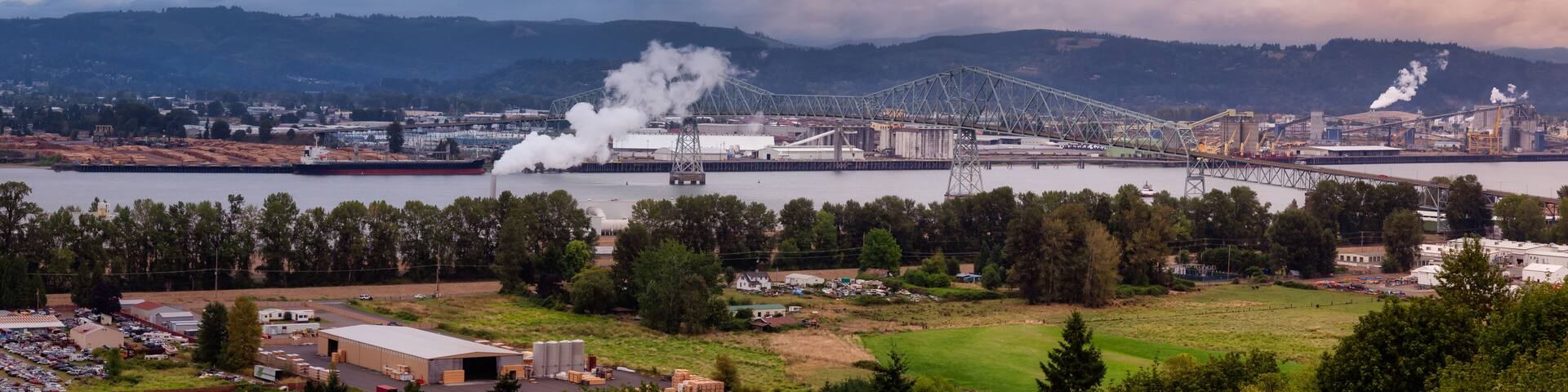 Longview, Washington, United States of America. Aerial Panoramic View of Port, Industrial Sites and Lewis and Clark Bridge over Columbia River. Sunrise Sky