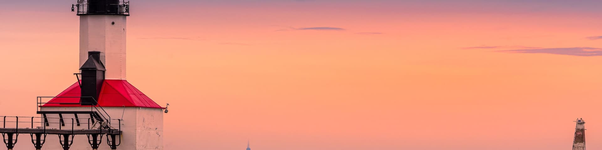 Michigan City, Indiana / USA 05/21/2019: Lighthouse During golden Hour with Chicago in the background.