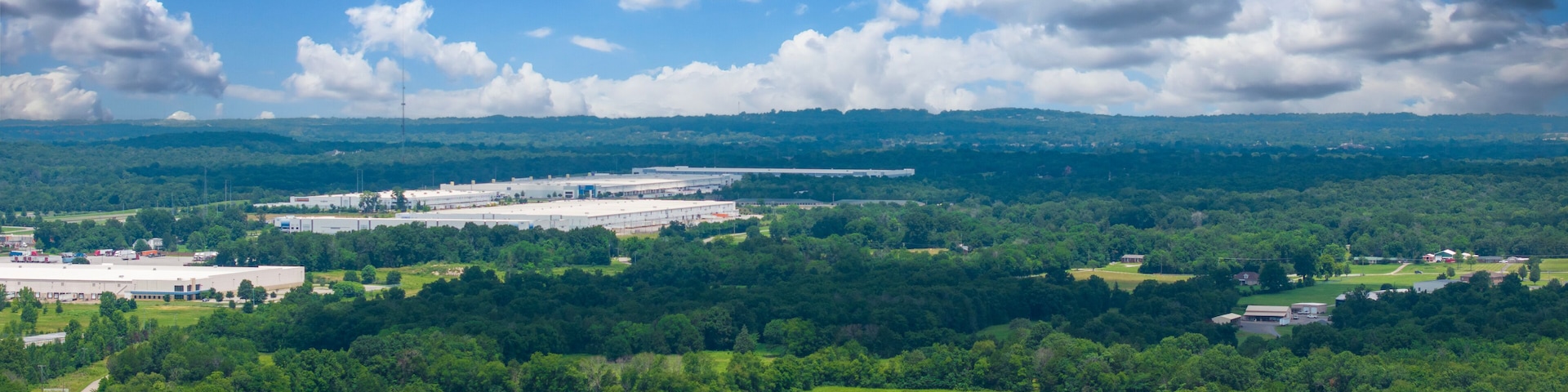 aerial shot of vast miles of lush green trees and the ALDI distribution center at the Nashville Superspeedway in Lebanon Tennessee USA