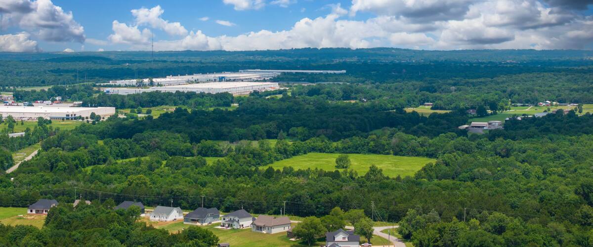 aerial shot of vast miles of lush green trees and the ALDI distribution center at the Nashville Superspeedway in Lebanon Tennessee USA