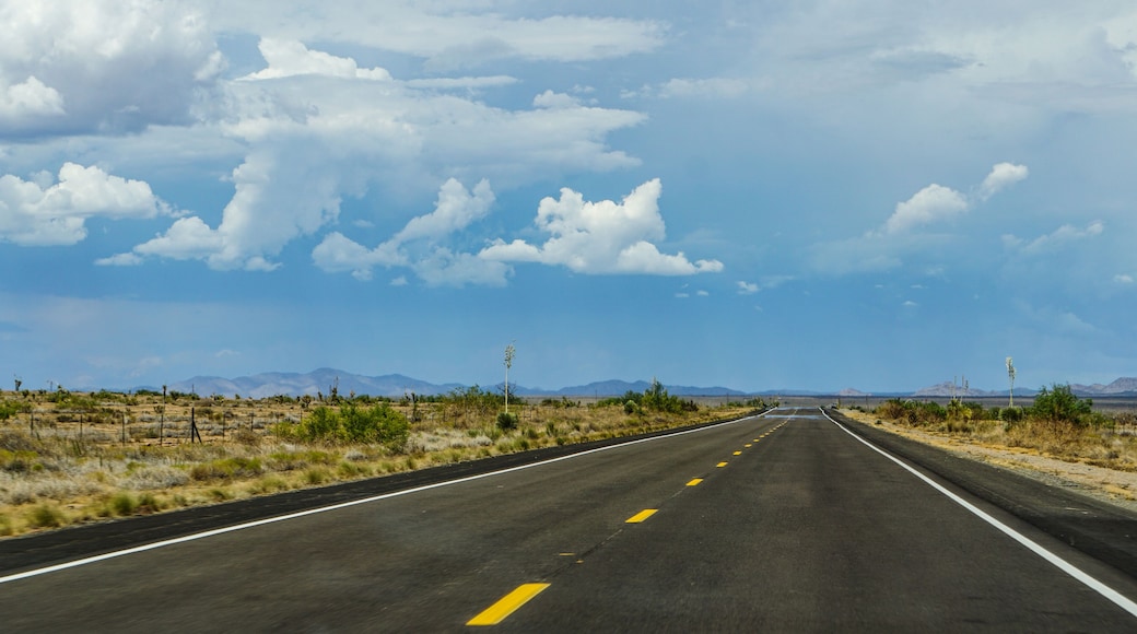 New Mexico highway state route 90, northbound from Lordsburg to Silver City, Gila Mountains in the distance above heat waves on the pavement