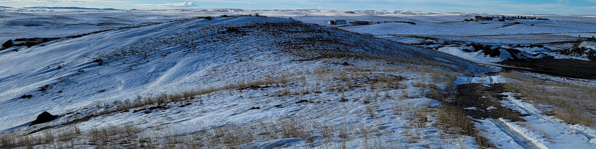 View from the snowcapped hill. Close to the dump in Lusk Wyoming, on a hill by the cemetery, the view is great with the snow on the ground. Trail road on the far right is the only way up and down.
