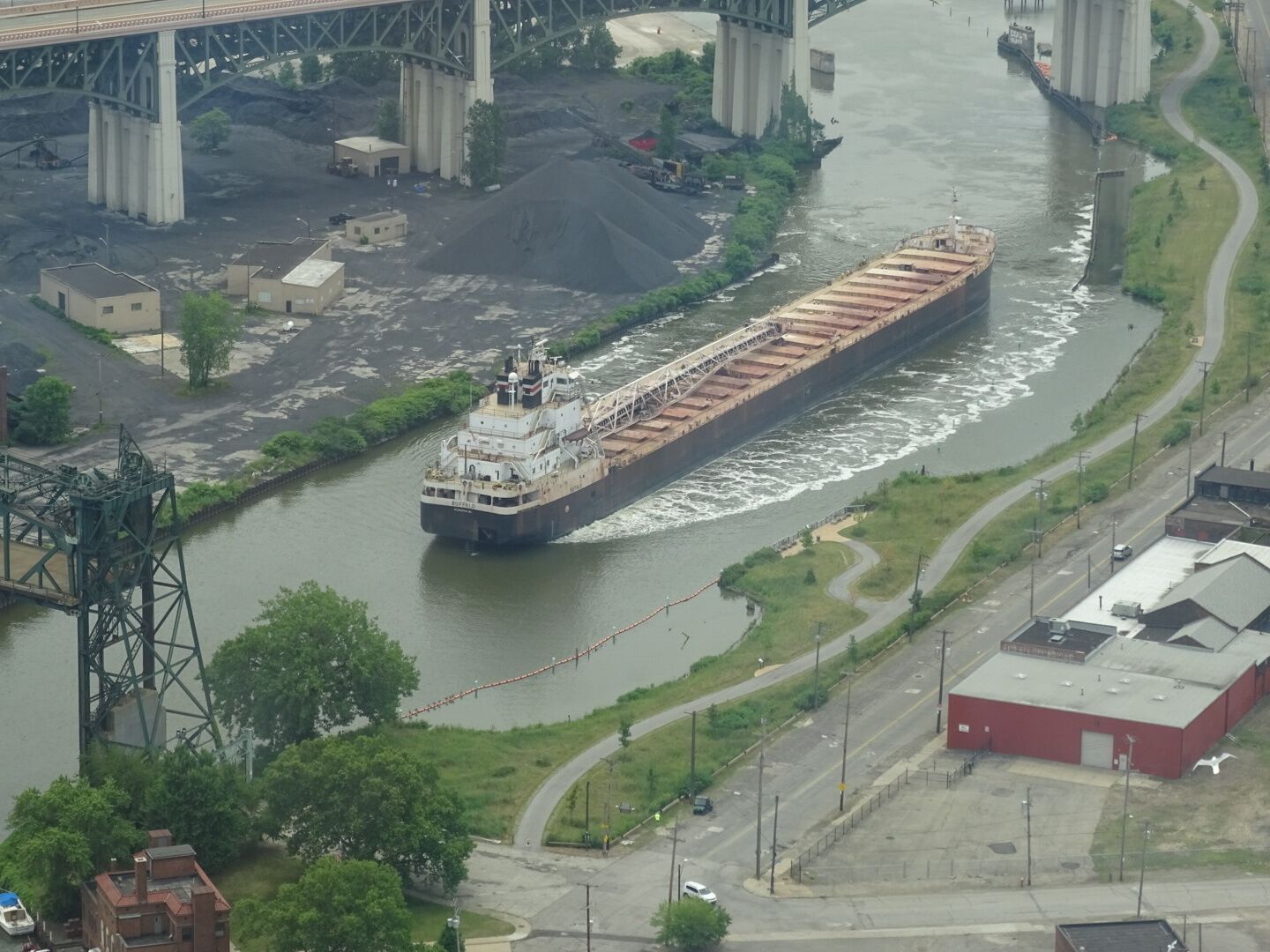 A large freighter navigating the crooked path of the Cuyahoga River.