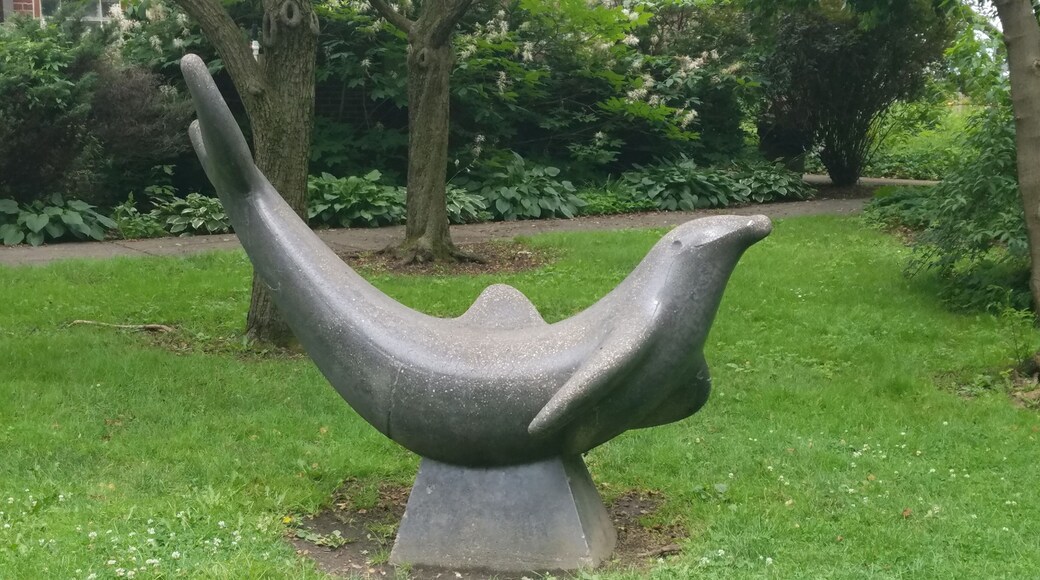 A statue of a playful Porpoise on the grounds of the park.