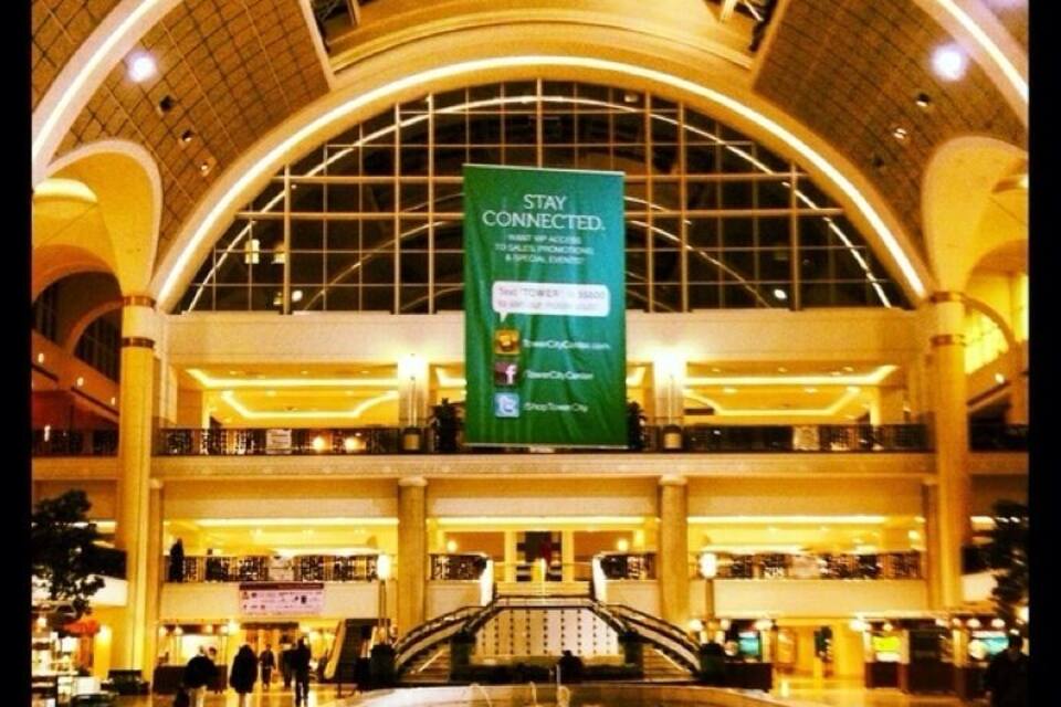 A spacious indoor area with a large fountain, a high arched ceiling, and a banner advertising connectivity services.