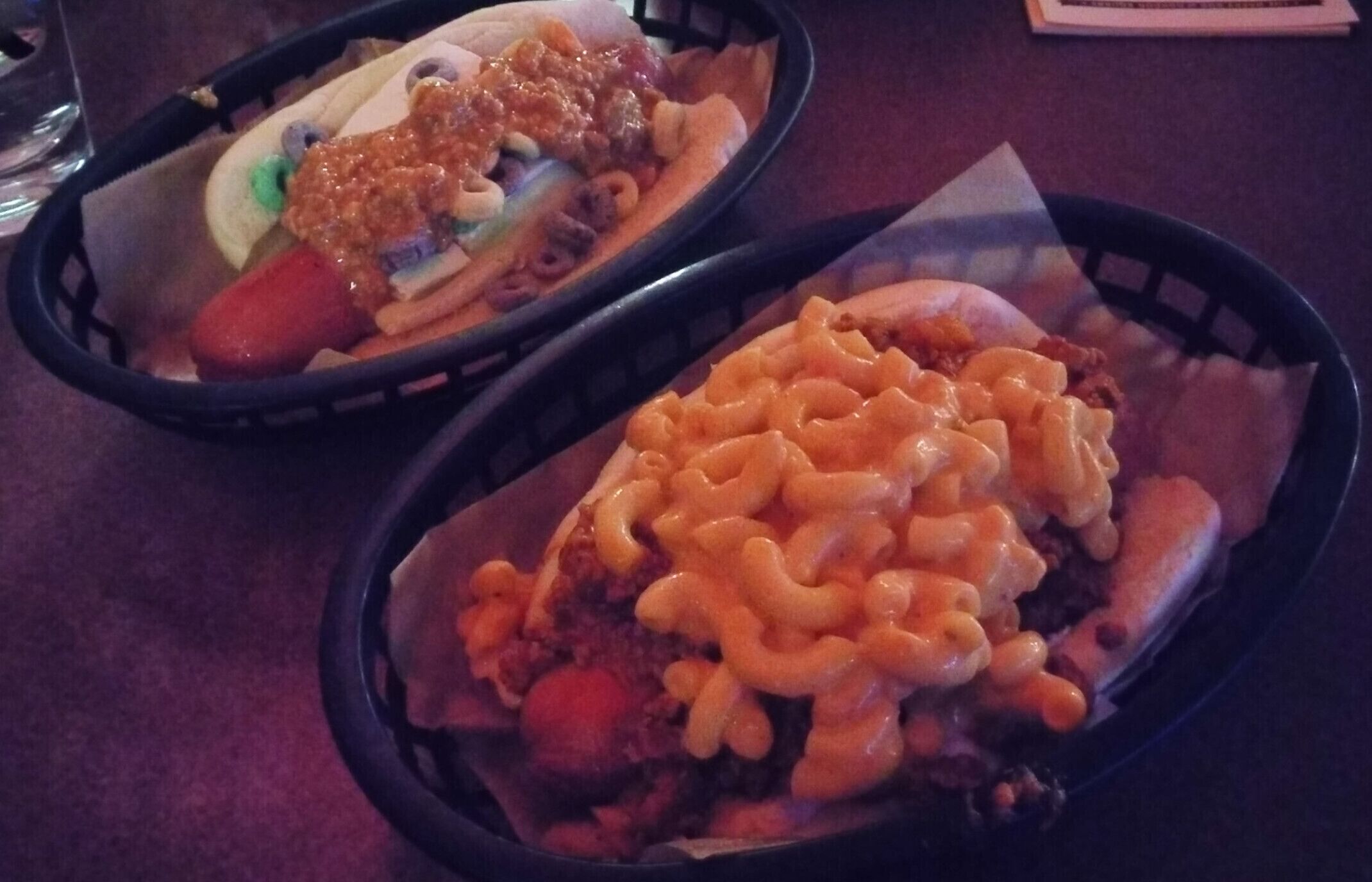 Happy Dog has over 50 toppings to make your dog happy!

Check out these custom creations: 

In front, spanish onions, chorizo chili and pimento mac & cheese.

Bringing up the rear, a dill pickle spear, brie cheese, chunky peanut butter AND Froot Loops cereal!