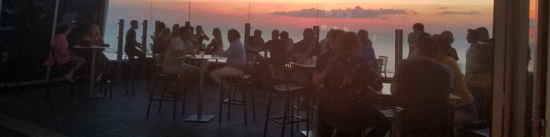 View of the July sunset over Lake Erie from inside the 32nd floor rooftop bar. This is atop the Downtown Hilton.