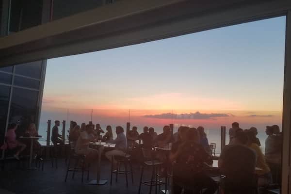 View of the July sunset over Lake Erie from inside the 32nd floor rooftop bar. This is atop the Downtown Hilton.