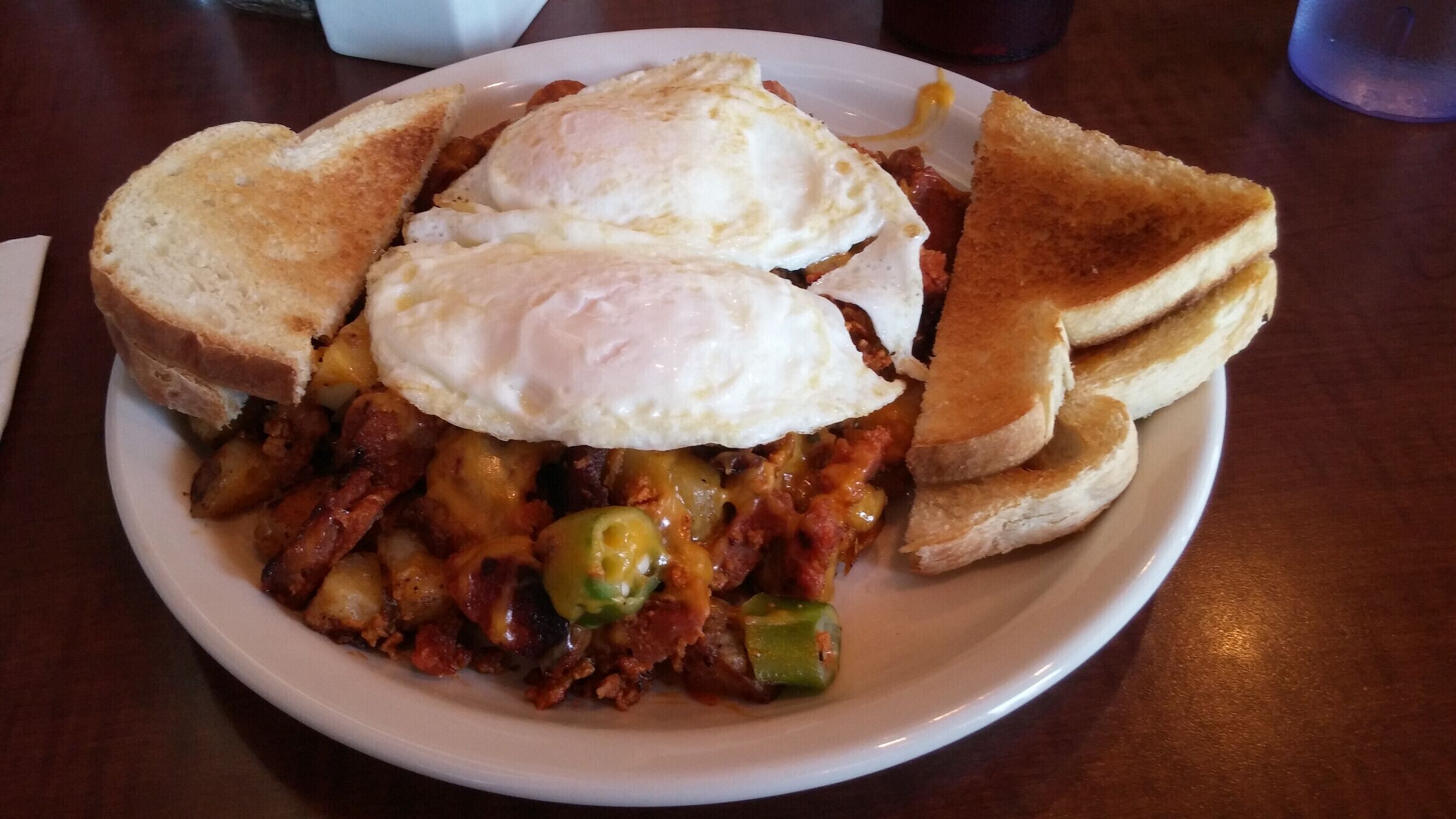Walker Hash - Two eggs, chorizo sausage, andouille sausage, okra, cheddar cheese and Cajun home fries 