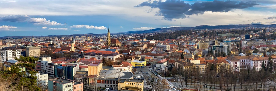 Aerial panoramic view of Cluj Napoca city over the famous cultural landmarks in town in a daytime , Romania