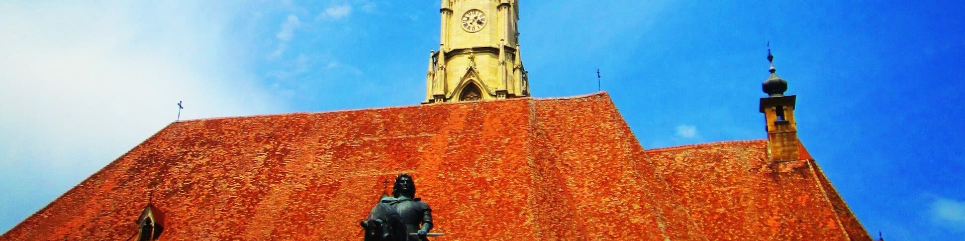 The Church of Saint Michael is a Gothic-style Roman Catholic church in Cluj-Napoca. It is the second largest church (after the Black Church of Brașov) in the geographical region of Transylvania, Romania. The nave is 50 meters long and 24 meters wide, the apse is 20×10 m. The tower with its height of 76 meter (80 meter including the cross) is the highest one in Transylvania. The western portal is decorated with the three coats of arms of Sigismund as King of Hungary, as King of Bohemia and as Holy Roman Emperor.
Source:Wikipedia