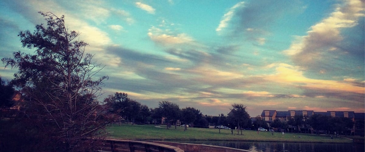 Quaint little park with some walking trails and pond. Located next to a small shopping center. Nice place to spend an afternoon. 
This picture was taken on the wraparound bridge on the water.