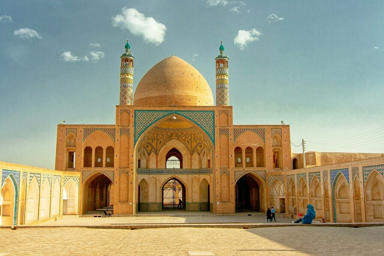 March 2009 
Agha Bozorg mosque 
This mosque and madrasah was built in late 18th century for Mullah Mahdi Narakhi called Agha Bozorg, hence the name of it. 
It has two courtyards, one sunken (not in picture) where a water pool and student rooms are located. In north of the ground level there is a fine dome with 2 pinnacles for calling to prayers and a prayer space (shabestan). 
Built of bricks and decent tiles it is another marvel in the historical part of Kashan town. 