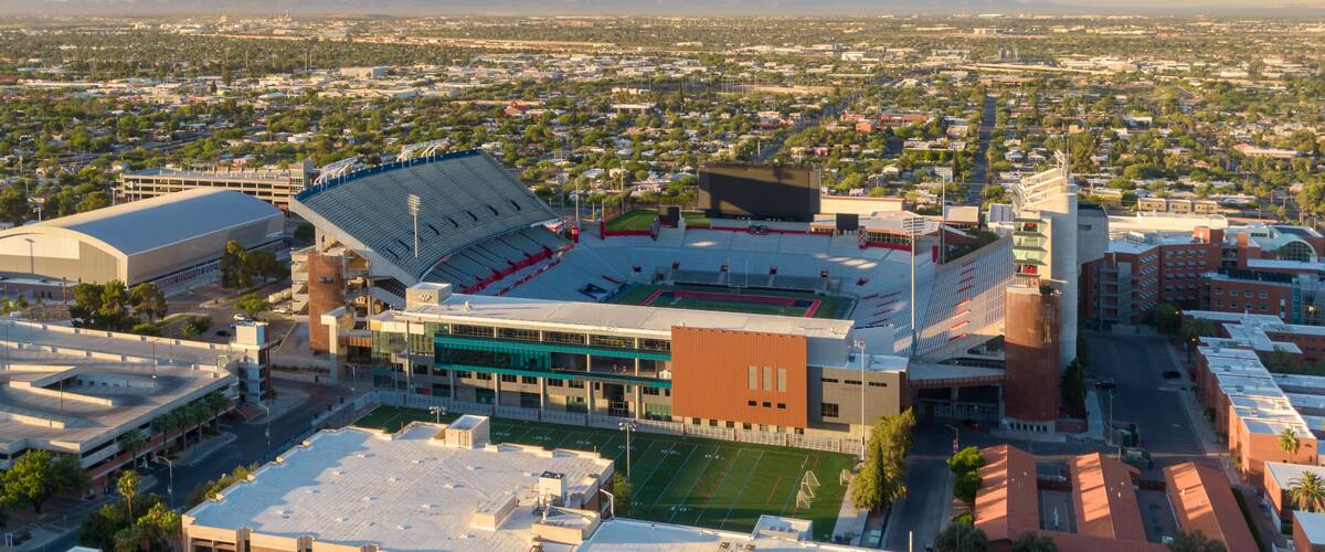 A stadium with a large seating area and a football field.