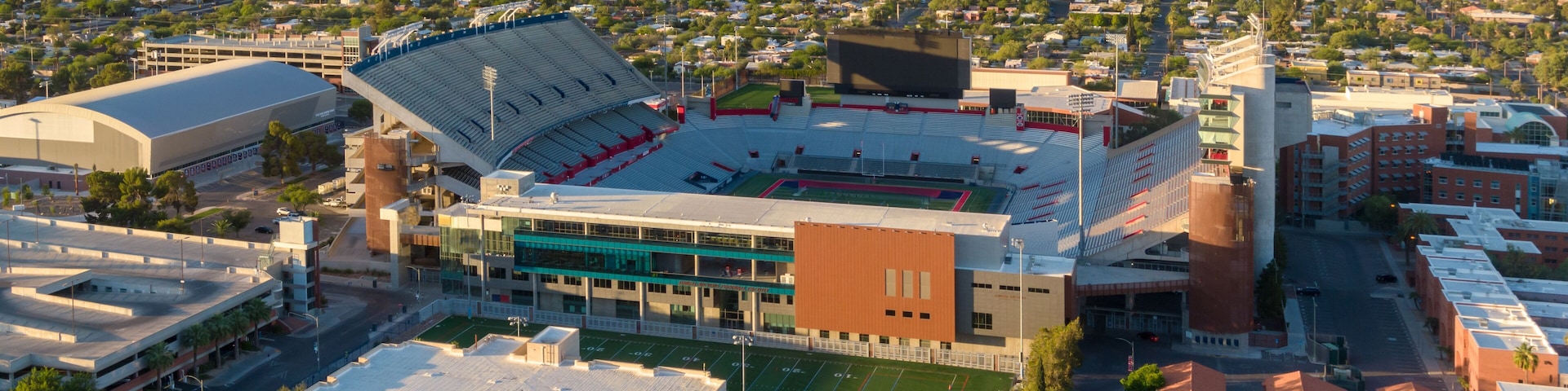 A stadium with a large seating area and a football field.