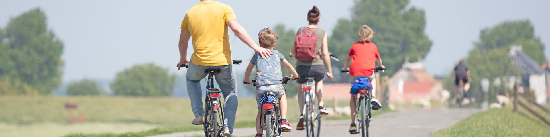 Cyclists cycling on a dyke