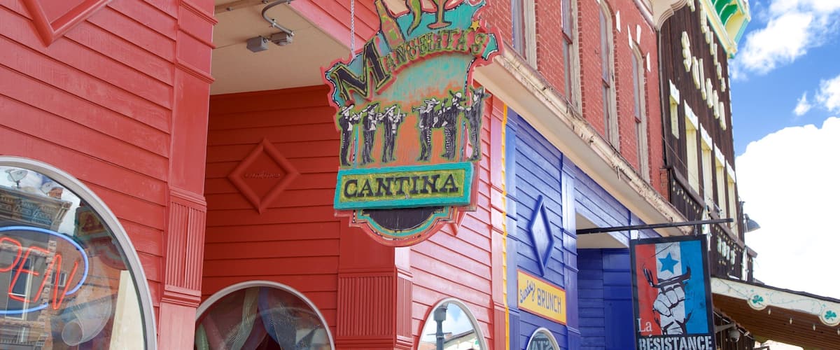 A colorful building with a sign reading "Cantina" and another sign for "La Resistance Coffee".