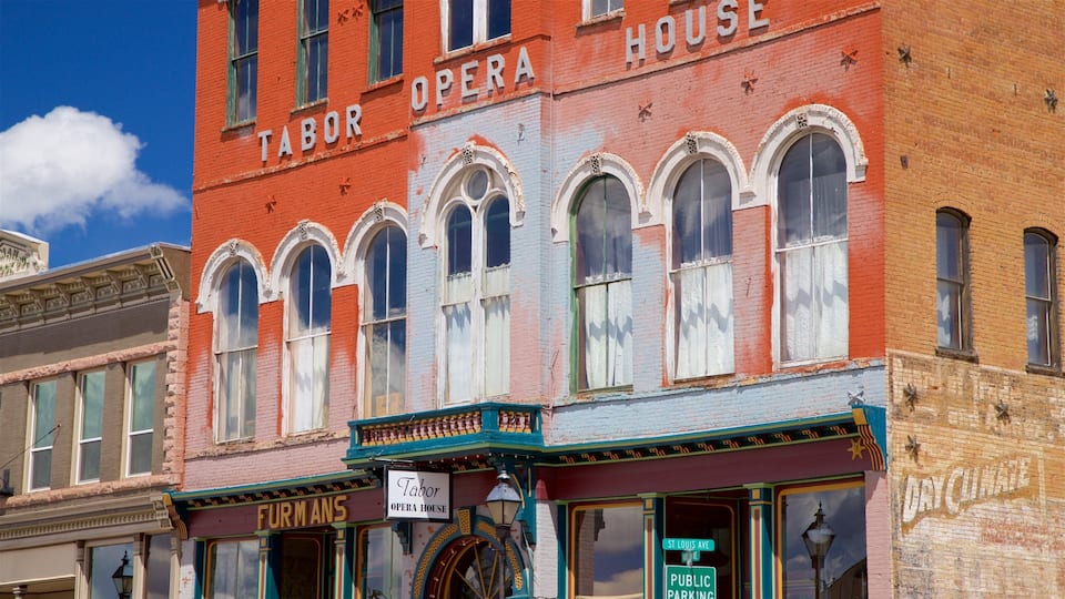 A historic opera house with a sign reading "Tabor Opera House" and a street sign for "St. Louis Ave."