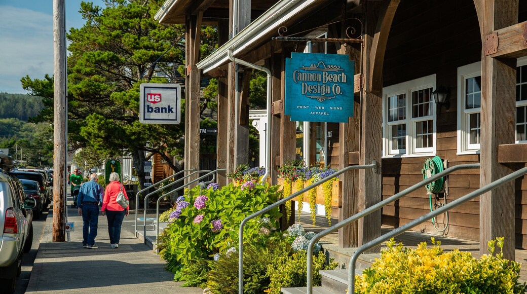 Cannon Beach showing signage and street scenes as well as a couple