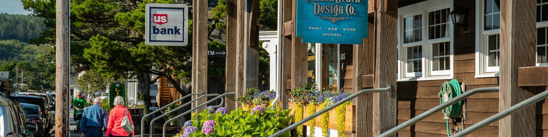 Cannon Beach showing signage and street scenes as well as a couple