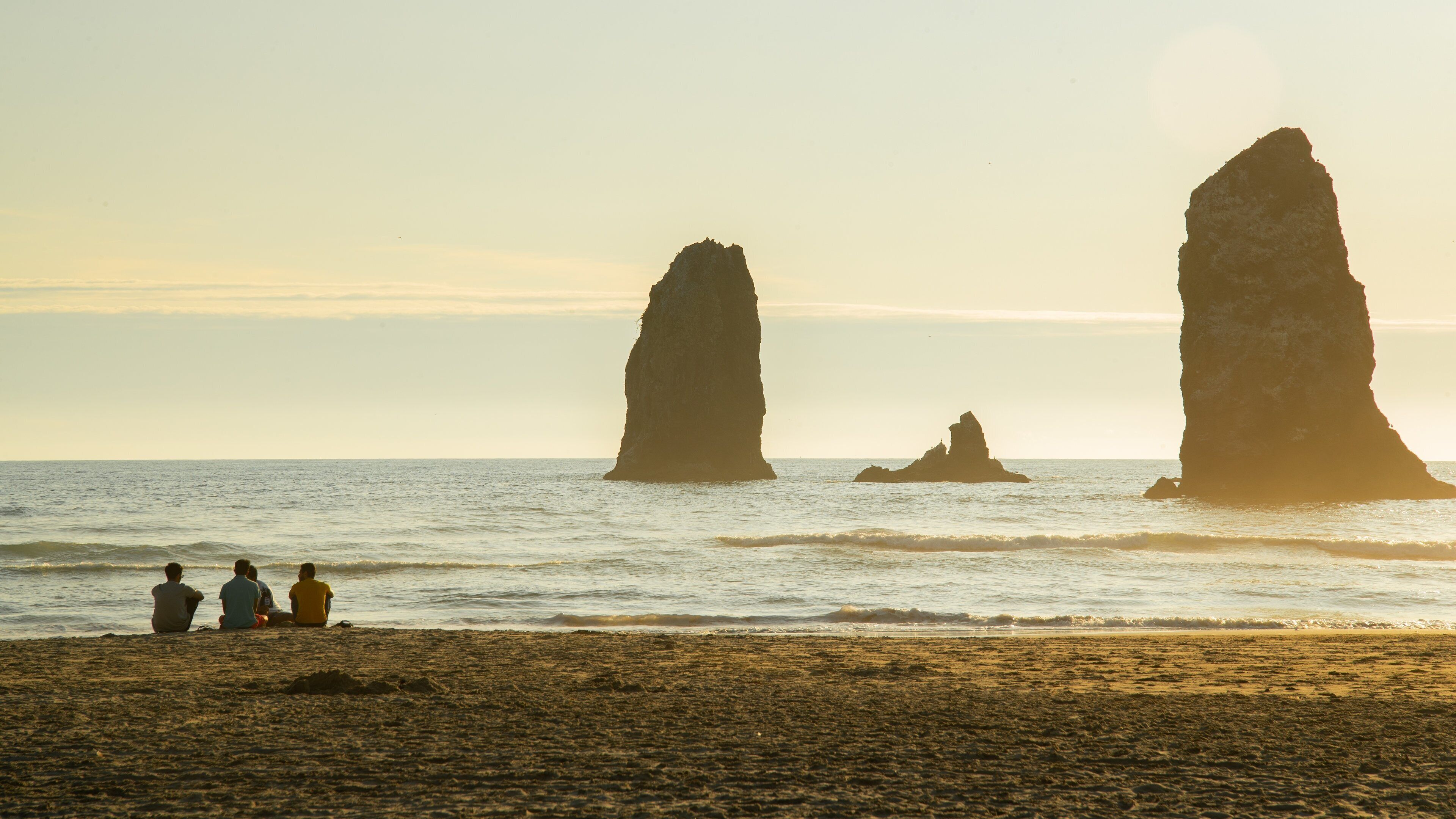 Cannon Beach which includes a beach, general coastal views and a sunset