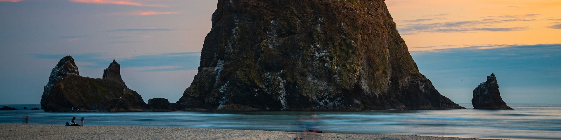 Cannon Beach featuring island views, a sunset and general coastal views