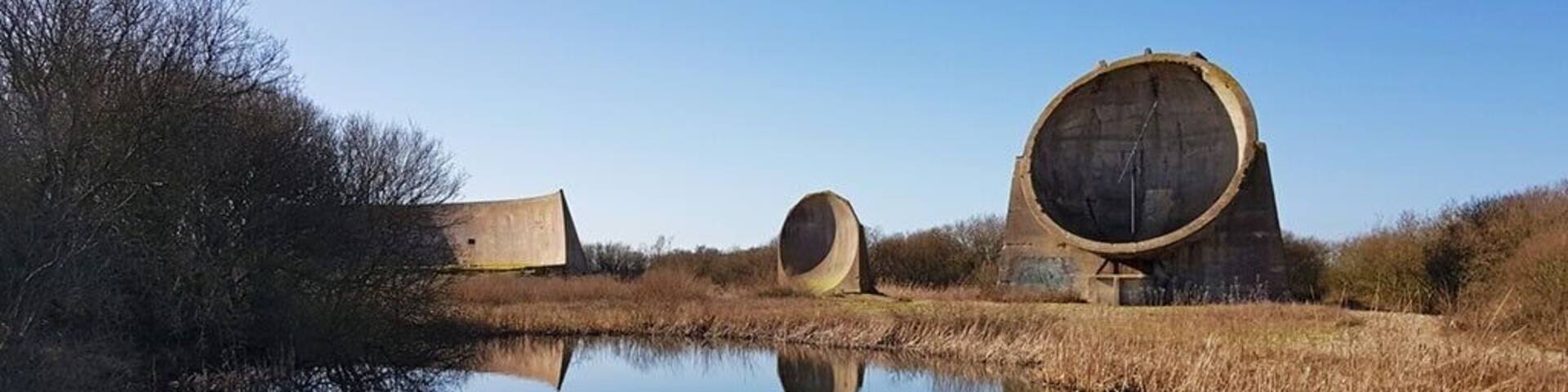 The Sound Mirrors in Dungeness.
Designed and built by Percy Rothwell these are a forerunner of radar and were built on the south and northeast coasts of England between about 1916 and the 1930s.
They were intended to provide early warning of incoming enemy aeroplanes and airships about to attack coastal towns.
With the development of faster aircraft the sound mirrors became less useful, as an aircraft would be within sight by the time it had been located, and radar finally rendered the mirrors obsolete.