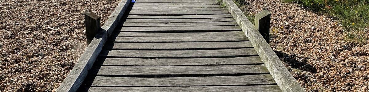 A path leads through the "desert" of Dungeness to the sea. #LocalSecrets #Trovember