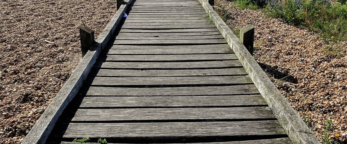 A path leads through the "desert" of Dungeness to the sea. #LocalSecrets #Trovember