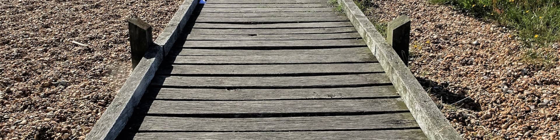 A path leads through the "desert" of Dungeness to the sea. #LocalSecrets #Trovember