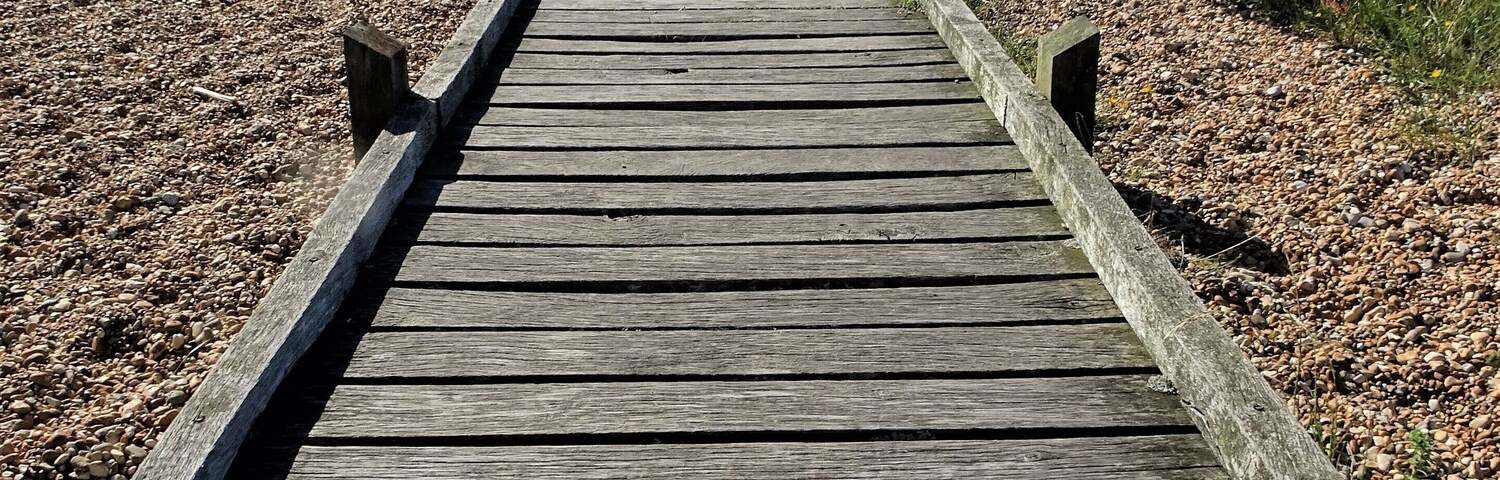 A path leads through the "desert" of Dungeness to the sea. #LocalSecrets #Trovember
