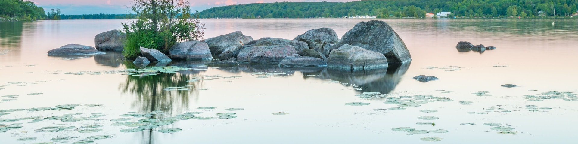 Granite rocks dot the still waters of Lower Buckhorn Lake at sunset.; Shutterstock ID 686766625; Purchase Order: -