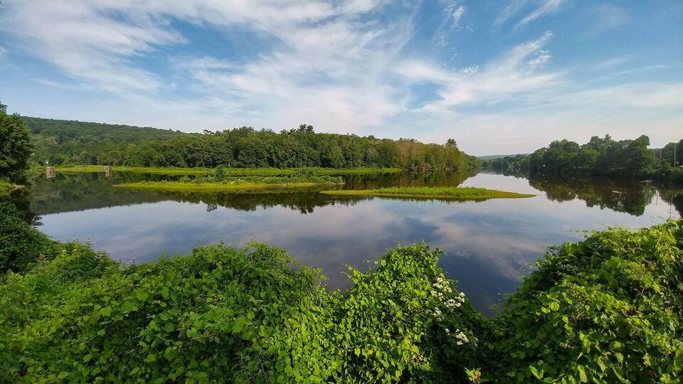 The Farmington river is perfect for kayaking and SUP, but before the paddlers get out, the still waters reflect the sky perfectly from this vantage on Bridge Street #Aquatrove