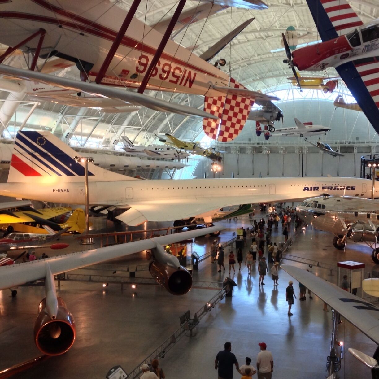 An indoor aviation museum with various aircraft on display, including a prominent Air France plane.